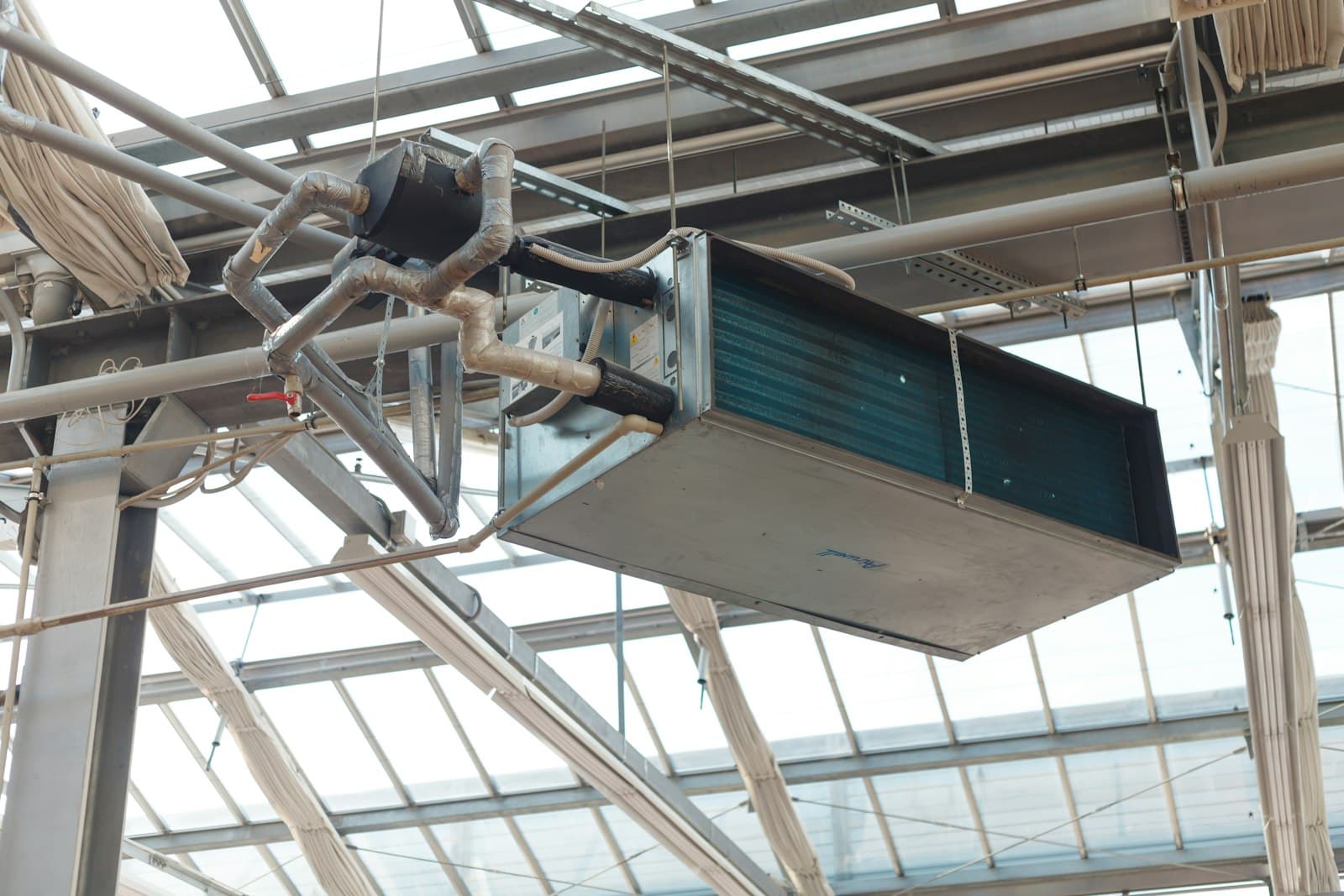 Ceiling-mounted air handling unit with insulated pipework