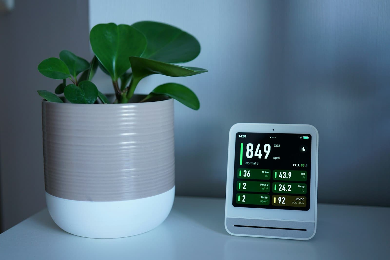 Indoor air quality monitor showing CO2 and particulate readings