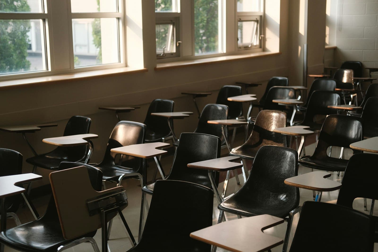 Empty school classroom with rows of desks